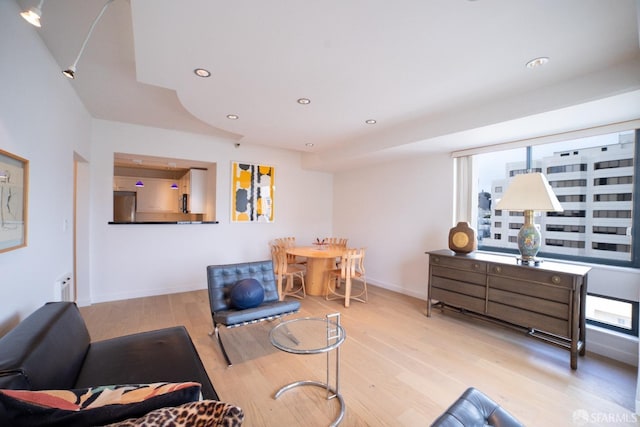 living room with light wood-type flooring and radiator heating unit