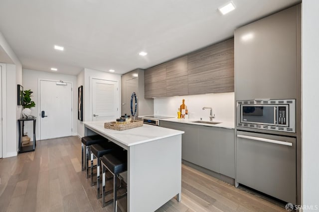 1605 Riviera Ave Unit 608, Walnut Creek, CA 94596 - kitchen featuring stainless steel microwave, dishwasher, a kitchen bar, modern cabinets, and a center island