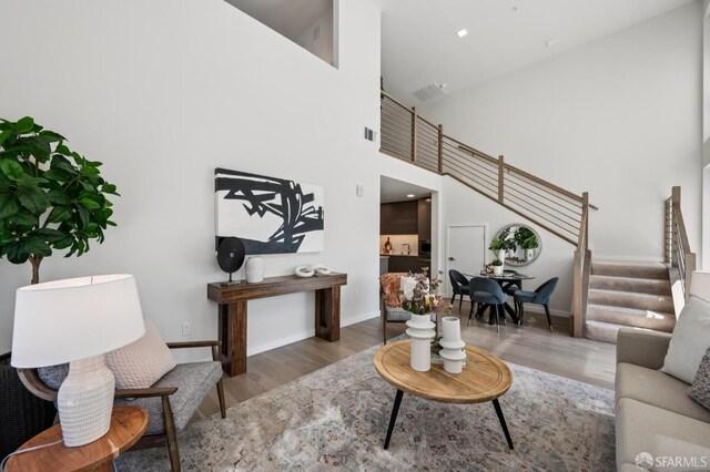 1605 Riviera Ave Unit 608, Walnut Creek, CA 94596 - living room featuring stairs, wood finished floors, and a towering ceiling