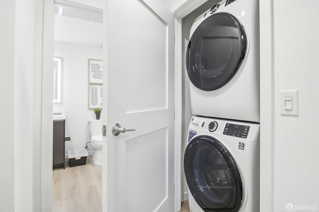 52 Kirkwood Ave Unit 321, San Francisco, CA 94124 - washroom with stacked washer / dryer and wood finished floors