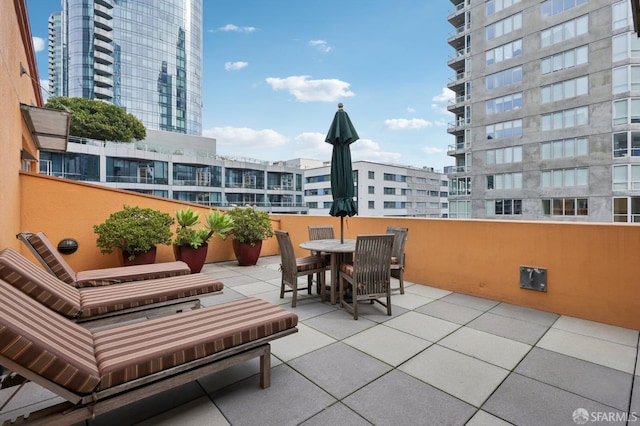 view of patio / terrace with a view of city and outdoor dining space