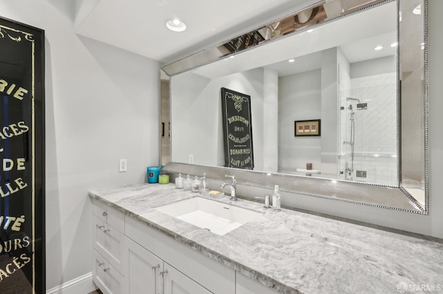 bathroom featuring a shower, recessed lighting, and vanity