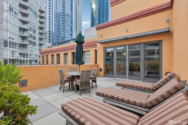 view of patio with a view of city and outdoor dining area