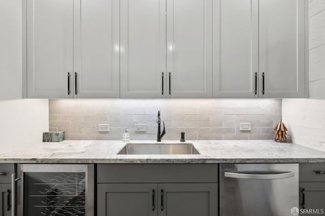 interior space featuring gray cabinets, beverage cooler, a sink, and stainless steel dishwasher