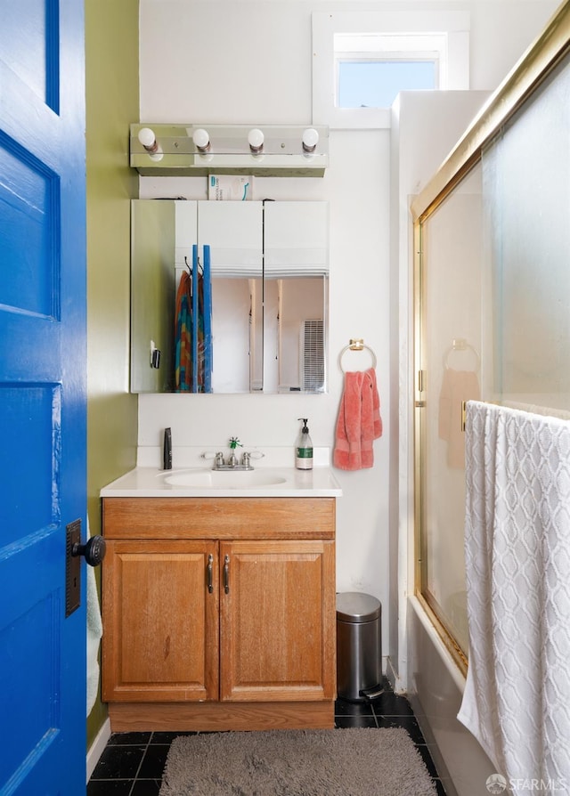 full bath featuring shower / bath combination with glass door, tile patterned flooring, and vanity