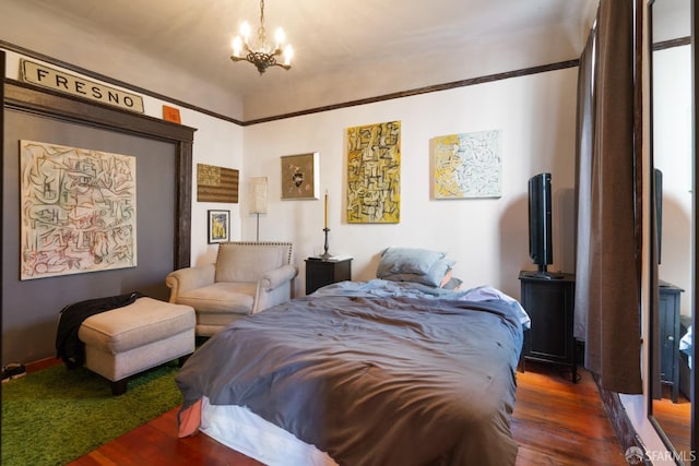 bedroom with a chandelier and dark wood-style flooring