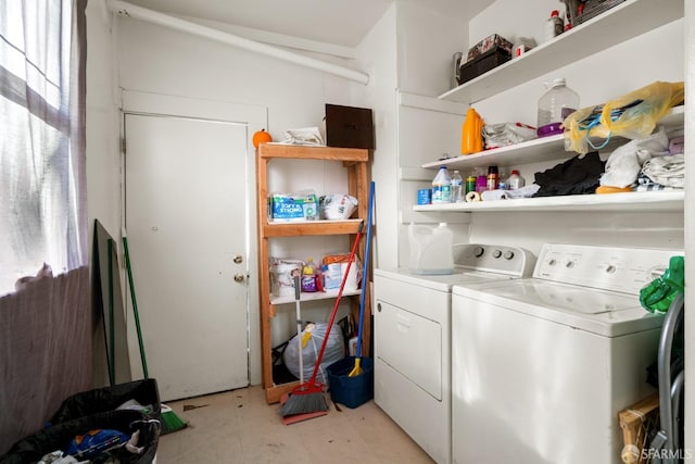 laundry area with laundry area, light floors, and washing machine and dryer