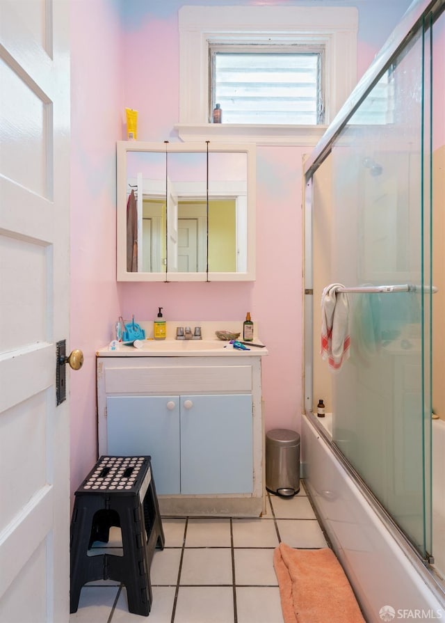 full bath featuring tile patterned flooring, enclosed tub / shower combo, and vanity