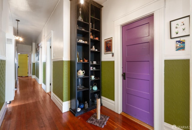 hall with dark wood-style floors and baseboards