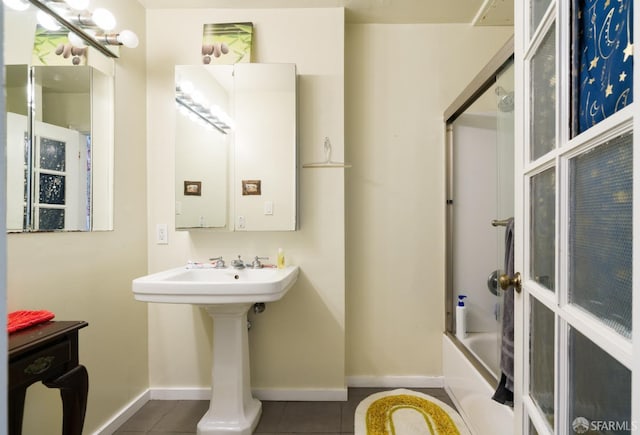 full bathroom featuring tile patterned flooring, bathing tub / shower combination, and baseboards