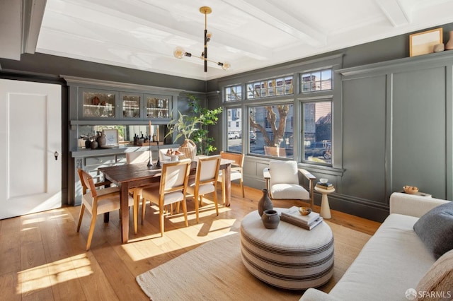 sunroom featuring an inviting chandelier, indoor bar, and beamed ceiling