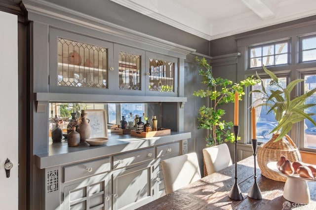 bar featuring beam ceiling and ornamental molding