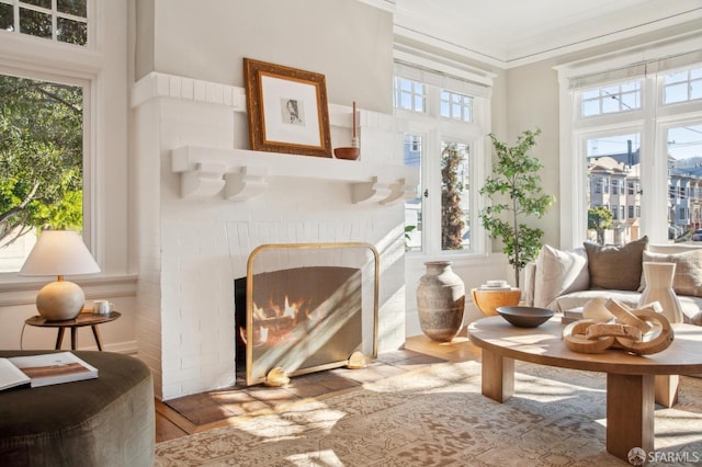 sitting room featuring a fireplace and crown molding