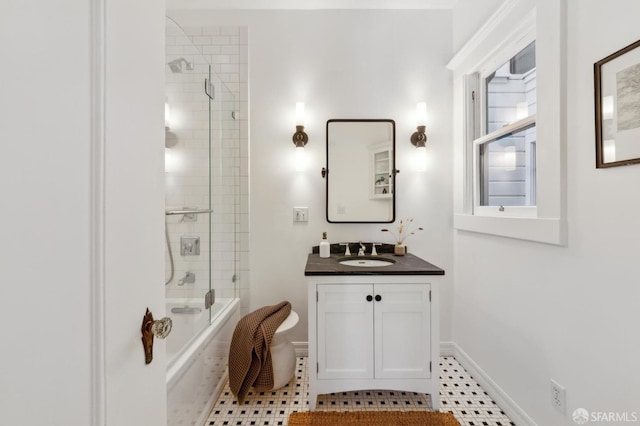 bathroom featuring tile patterned floors, vanity, and shower / bath combination with glass door