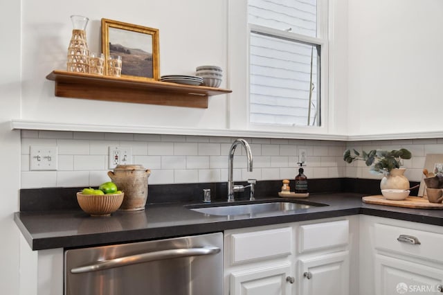 kitchen featuring sink, white cabinets, dishwasher, and tasteful backsplash