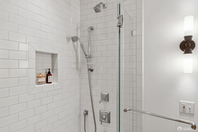 bathroom with a tile shower