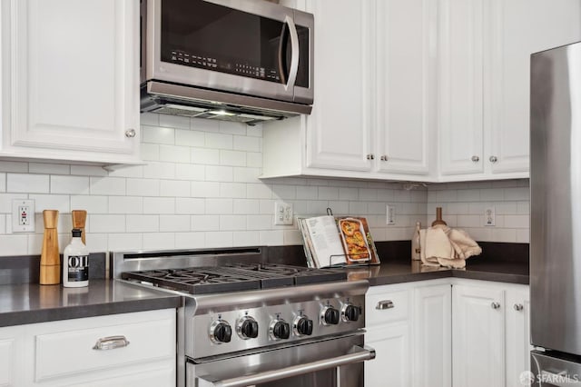 kitchen featuring backsplash, white cabinets, and stainless steel appliances