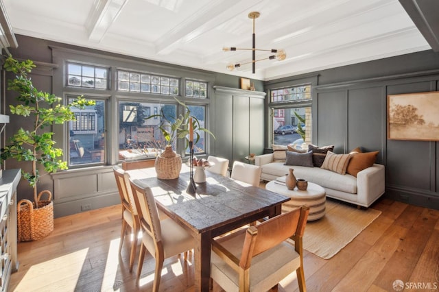 sunroom / solarium with a notable chandelier and beamed ceiling