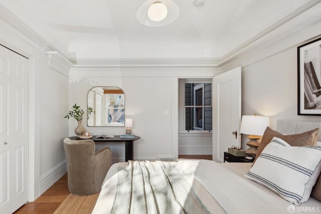 bedroom with a closet and hardwood / wood-style flooring