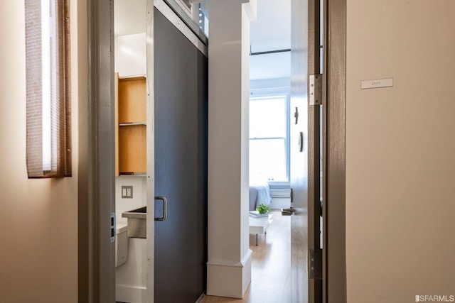 corridor featuring light wood finished floors