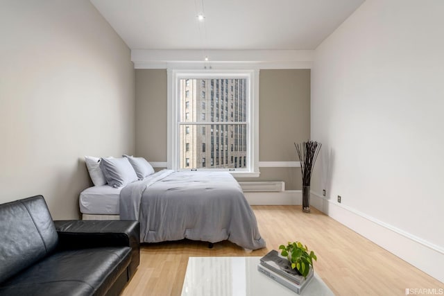 bedroom with baseboards and light wood-style floors