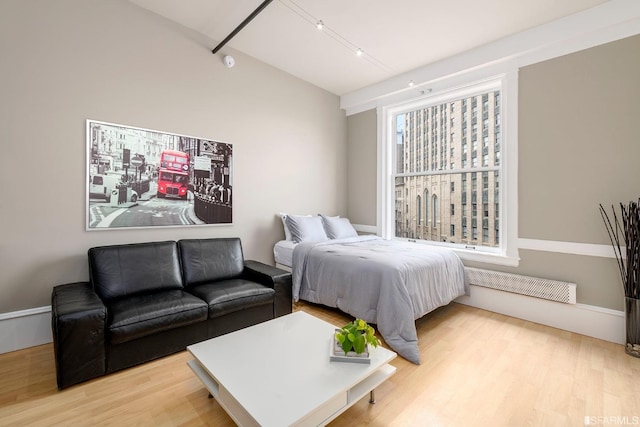 bedroom featuring wood finished floors and visible vents