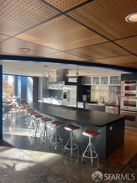 kitchen featuring a kitchen bar and stainless steel appliances