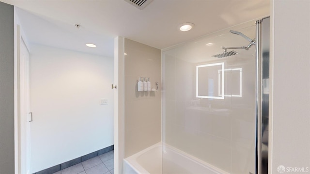 bathroom featuring tile patterned floors and tiled shower / bath combo