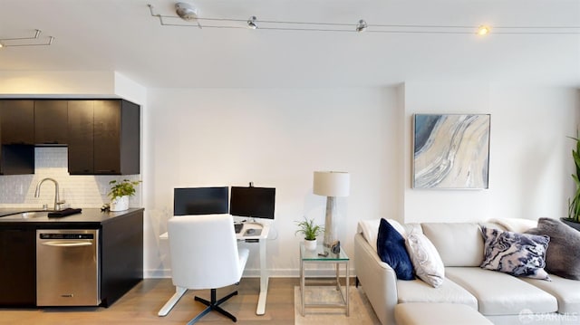 home office featuring light hardwood / wood-style floors and sink