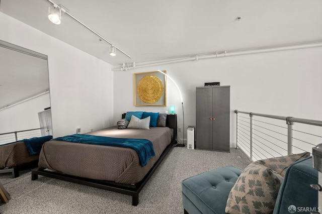bedroom featuring carpet flooring and rail lighting