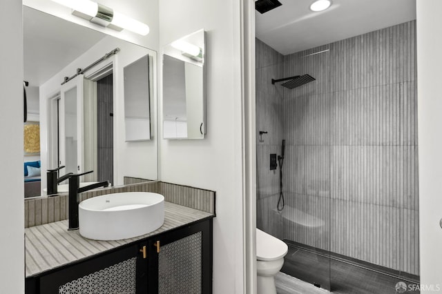 bathroom featuring vanity, toilet, and a shower stall