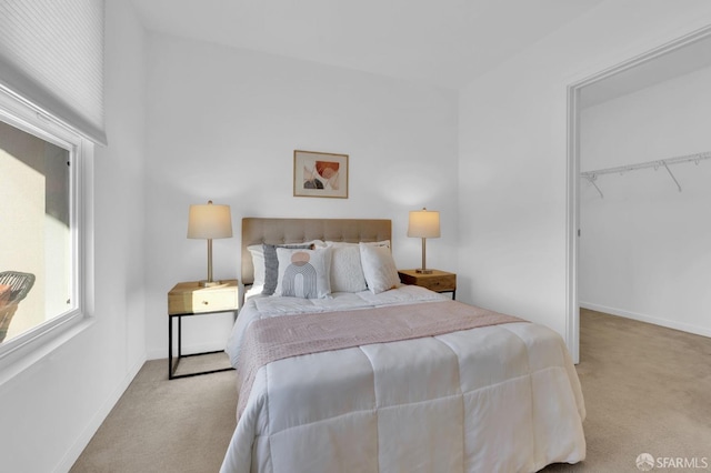 bedroom featuring light carpet and a closet