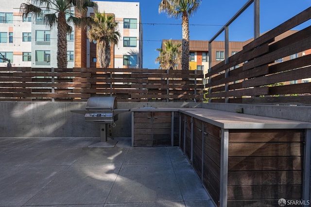 view of patio with grilling area and an outdoor kitchen