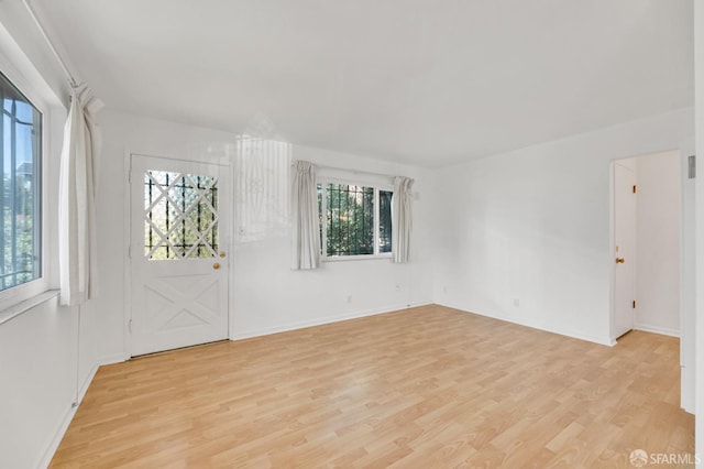 5020 Clarke St, Oakland, CA 94609 - foyer featuring plenty of natural light, light wood finished floors, and baseboards