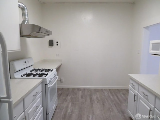5020 Clarke St, Oakland, CA 94609 - kitchen featuring light countertops, white cabinetry, gas range gas stove, and light wood-style floors