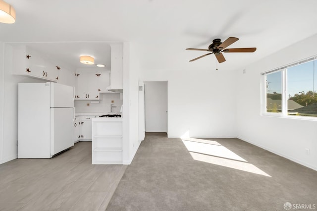5020 Clarke St, Oakland, CA 94609 - kitchen featuring ceiling fan, open shelves, light countertops, white appliances, and white cabinetry