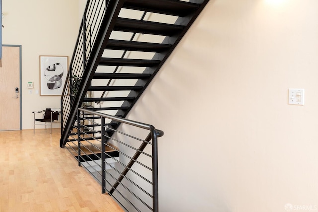 stairs featuring hardwood / wood-style flooring