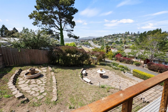 view of yard featuring a patio, an outdoor fire pit, and fence