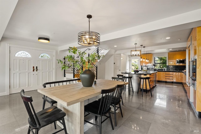 dining space with recessed lighting and a chandelier