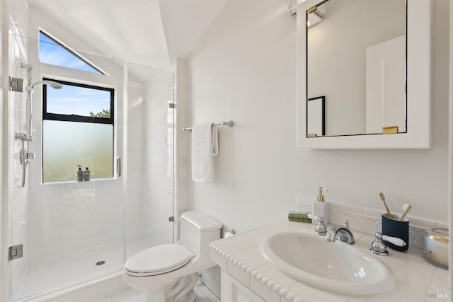 bathroom with vanity, a stall shower, a healthy amount of sunlight, and toilet