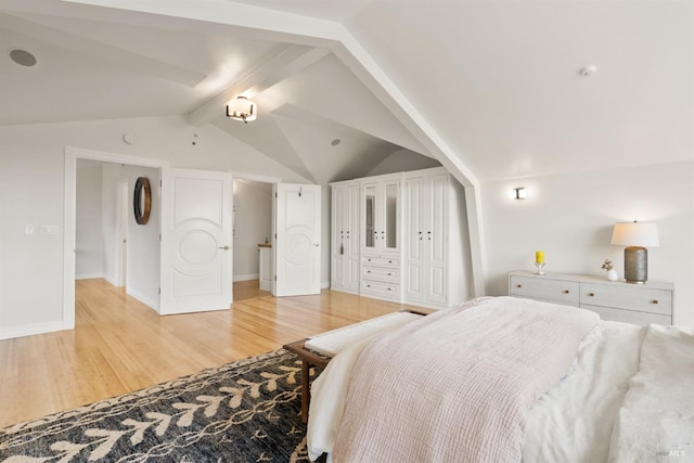 bedroom with light wood-style floors, lofted ceiling with beams, and baseboards