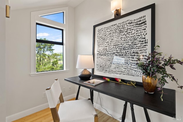 home office with baseboards and wood finished floors