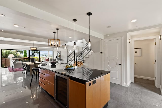 kitchen featuring dark countertops, recessed lighting, baseboards, wine cooler, and pendant lighting
