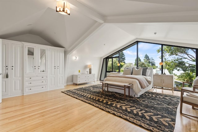 bedroom featuring vaulted ceiling and wood finished floors