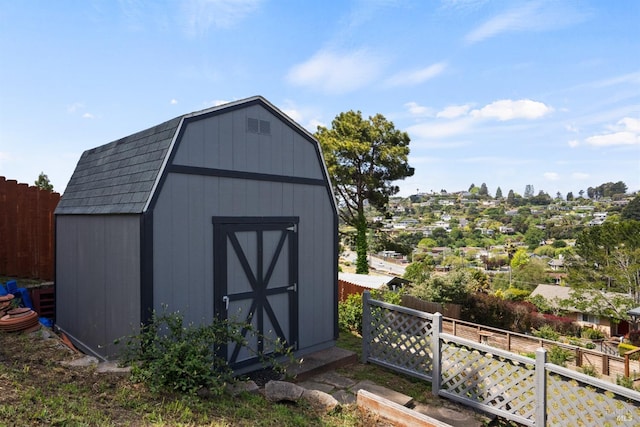 view of shed featuring fence