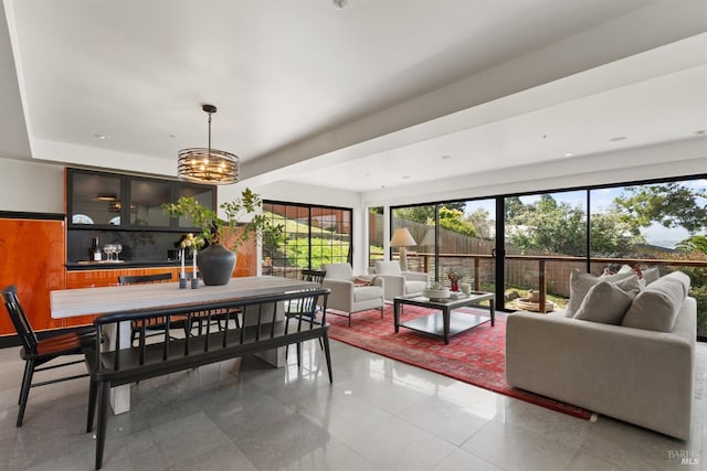 living room featuring light tile patterned flooring and a chandelier