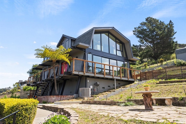 back of house featuring fence, a wooden deck, cooling unit, and stairway