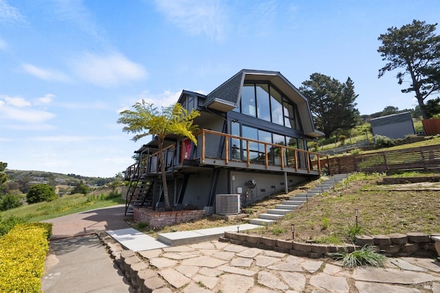 rear view of property featuring central air condition unit, fence, stairway, and a deck