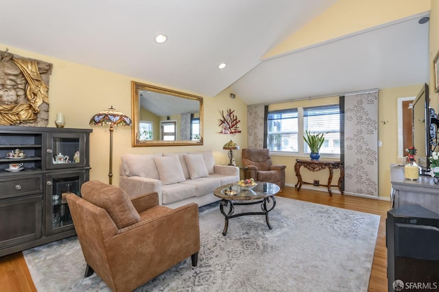 living room with lofted ceiling and light hardwood / wood-style flooring