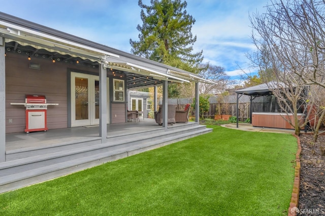 view of yard with a gazebo, a hot tub, and a deck